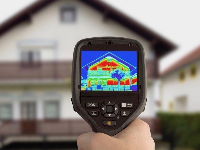 Hand held tester showing heat loss in a house